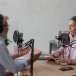 older man and female presenter in a recording studio create a podcast. senior, woman radio presenter